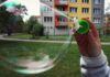 Wohnblock - davor Kinderhand mit Seifenblase