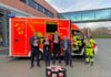 Feuerwehrchef Christoph Bahlmann (li.) bedankt sich zusammen mit den Notfallsanitätern Axel Kernbach und Torsten Brill bei Messe-Projektleiter Bernd Heinold (3.v.li.), vfdb- Projektkoordinator Ludwig (4.v.li.) und AVMS-Geschäftsführerin Hunsicker für die Spende der Stofftiere.