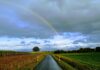 Nasse Straße mit Regenbogen