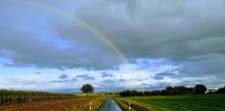 Nasse Straße mit Regenbogen