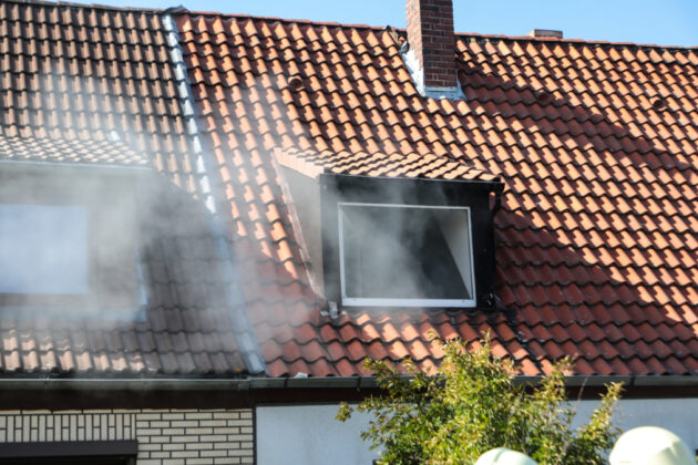 a smoke coming out of a window on a roof