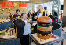 McDonald’s-Franchisenehmer David Ehmann und Restaurantleiterin Nadeschda Maier schneiden gemeinsam den Big-Mac-Kuchen an.
